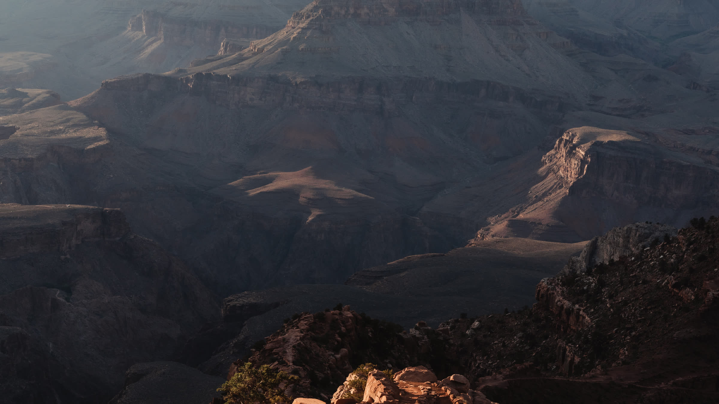 Late light and haze over canyon ridges seen from the rim