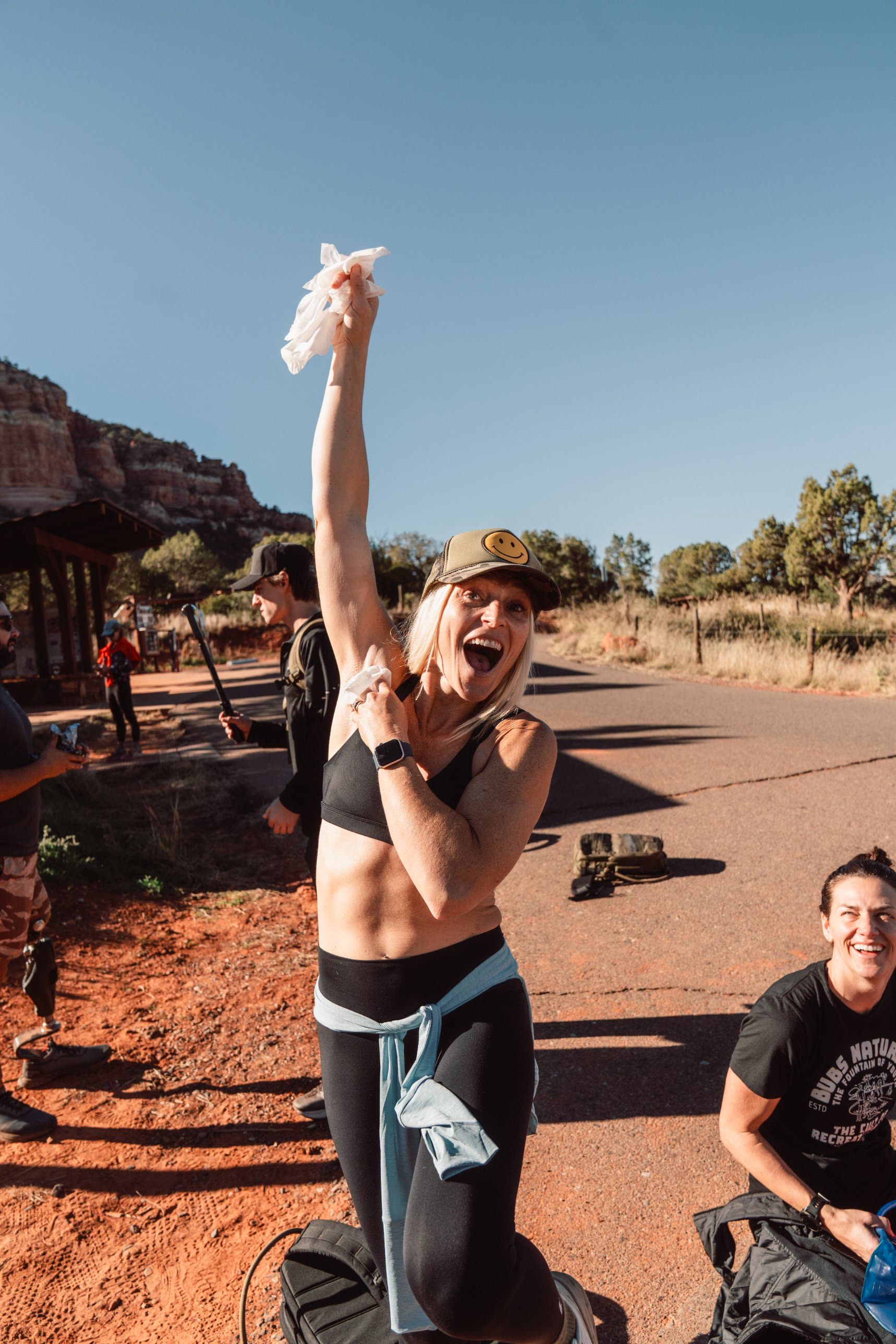 An athlete cheering with an arm raised at the finish