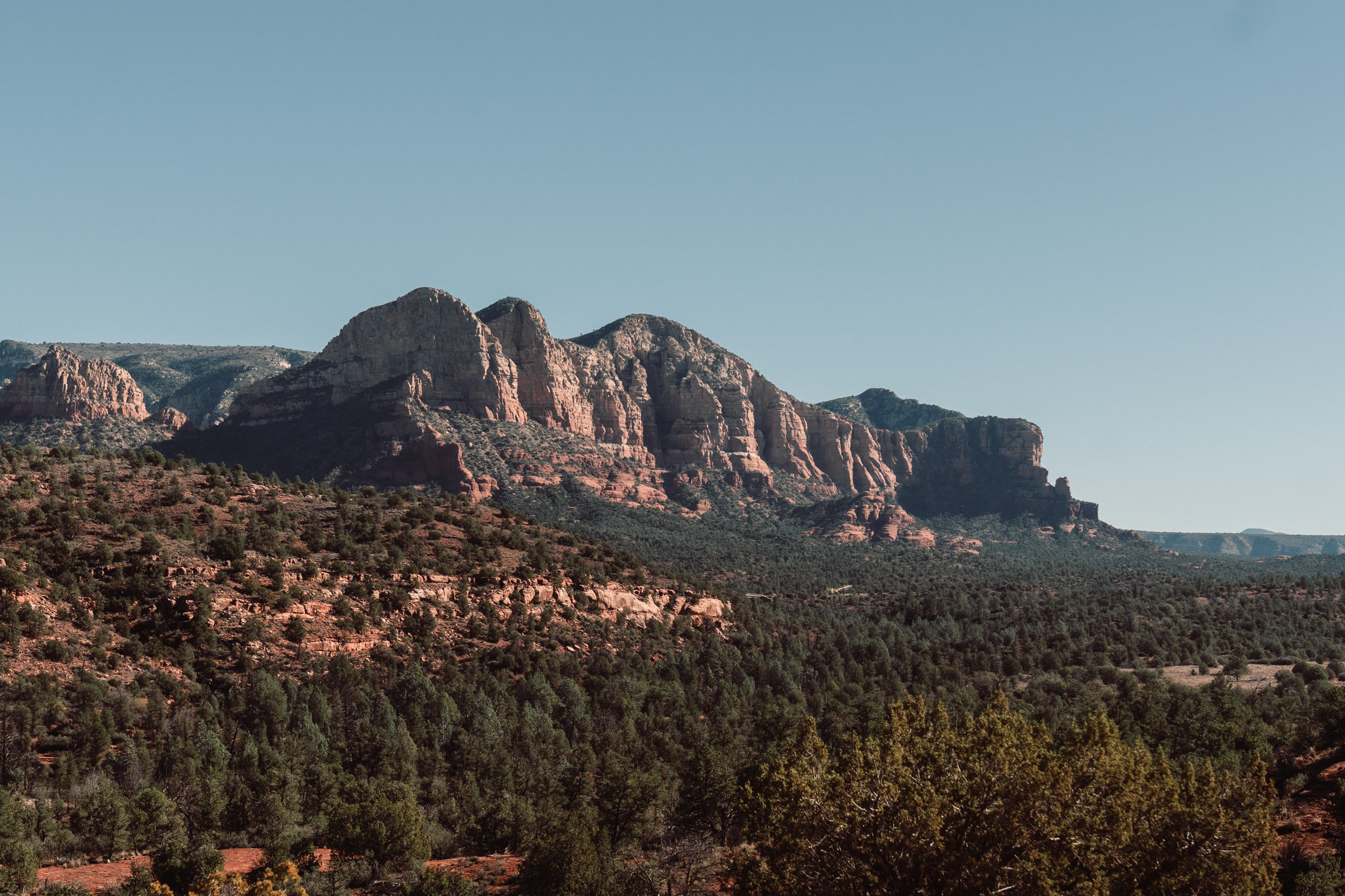 Red rock ridgelines above a forested valley